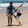 Teenager at the beach holding 1.6m Ikon stunt kite to show size