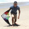 teenager on the beach holding a Stinger two string trick kite