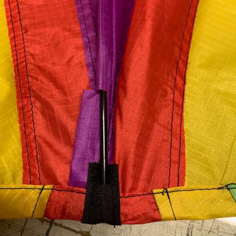 Black fabric pocket with fiberglass spine in it on a delta kite