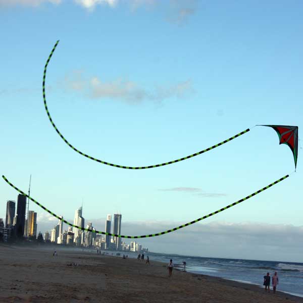 Twin tubular kite swooping the beach with surfers paradise in the background