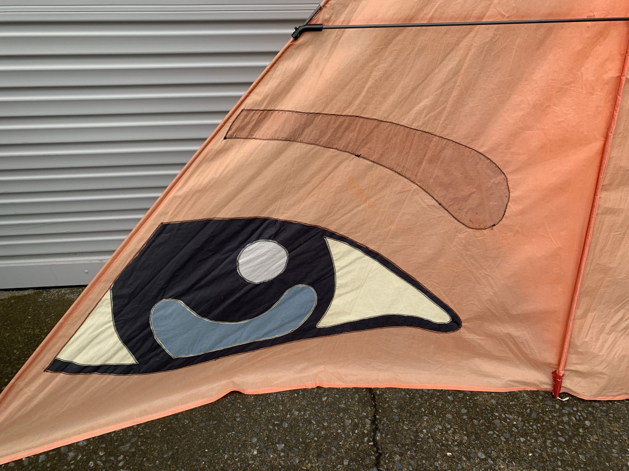 stitching detail on an orange delta kite sail