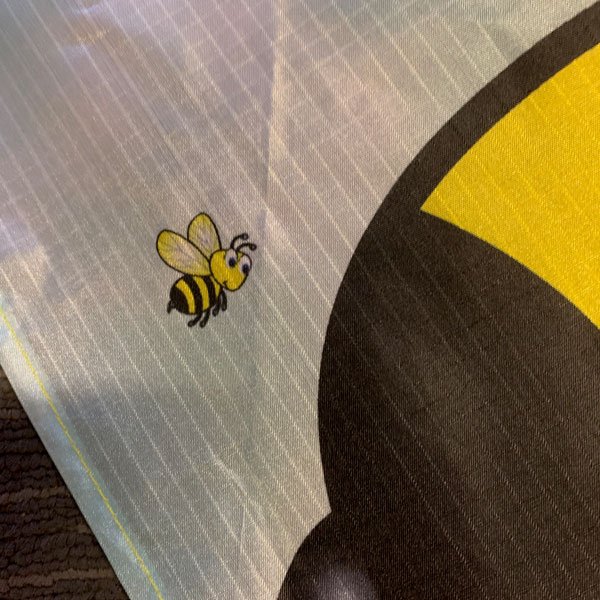 close up of small bee print on kite sail