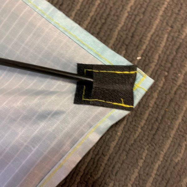 black fiberglass rod inserted into corner pocket on diamond kite