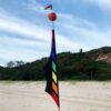 rainbow and black coloured banner on the beach