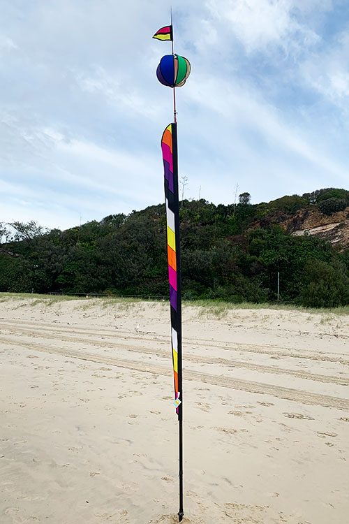flag, spinning ball and banner in the sand at the beach