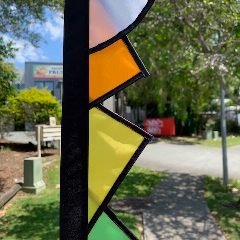 close up detail of coloured cloth on festival carousel banners