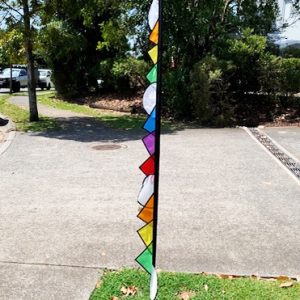 rainbow coloured carousel feather in the garden