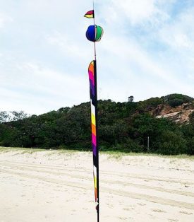 Licorice allsorts coloured thin banner on fiberglass pole with spinning ball above it