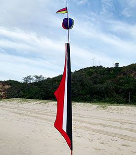 black red and white banner at the beach