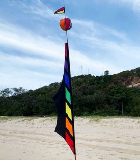 rainbow and black banner with spinning ball on top