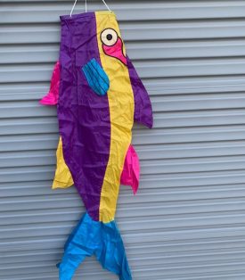 purple and yellow fish windsock against a wall