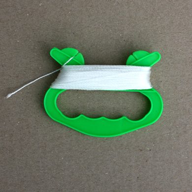 light cotton kite string on a green handle